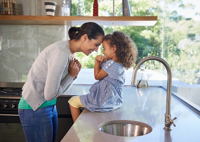 mother and daughter having fun in kitchen