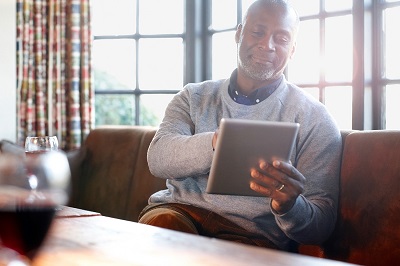 man relaxing with tablet