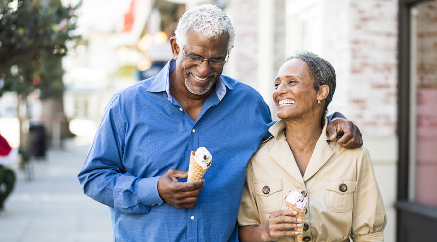 A senior African American couple enjoy an evening on the town with ice cream